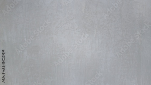Textured gray background: a simple yet captivating image featuring a textured gray background, perfect for various design applications. Emphasizing the subtleties of light and shadow.