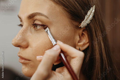 Close-up of makeup artist working on eye makeup