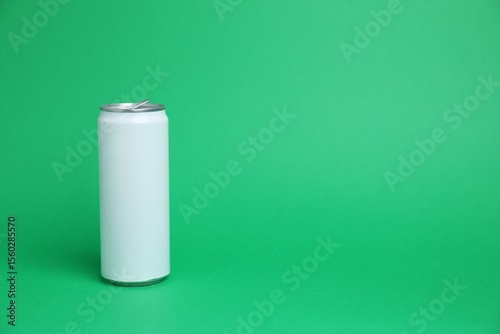 One white tin can on green background, space for text