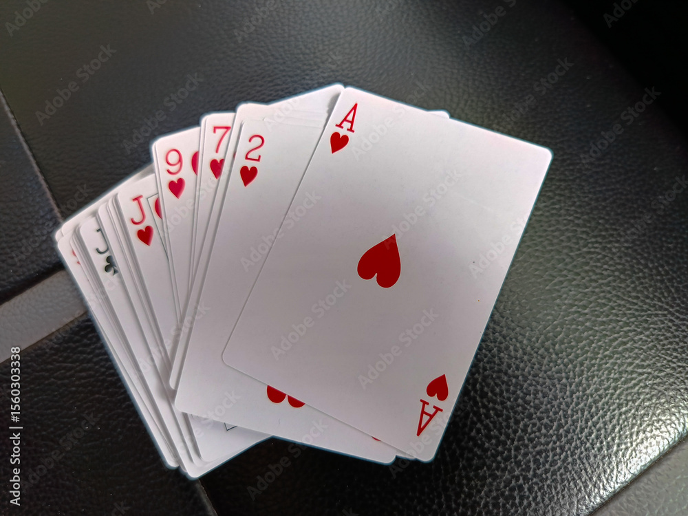 Obraz premium A set of playing cards with the top one as love.