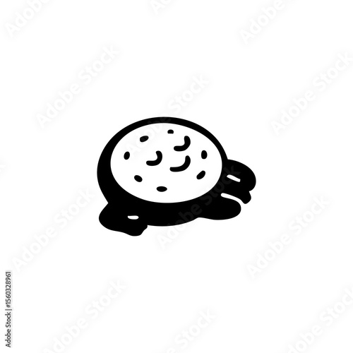 Round food item with small, textured details and dripping sauce