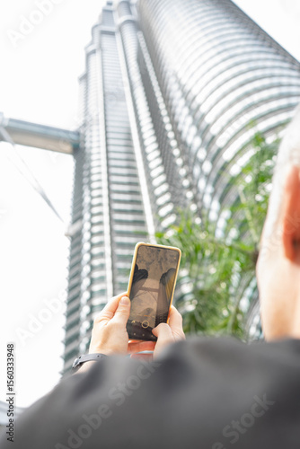 Photography Tourist taking photo with smartphone in kuala lumpur