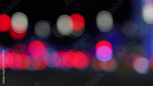 Blurred city lights at night creating colorful bokeh circles. Perfect for use as an abstract background, dreamy nightscape, or technology concept. Ideal for web design, presentations, advertising
