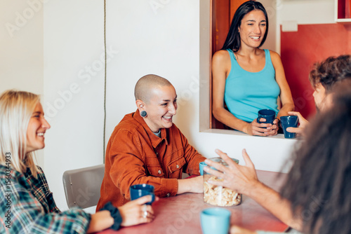 Diverse friends enjoying coffee and conversation at home - youth hostel - coliving 