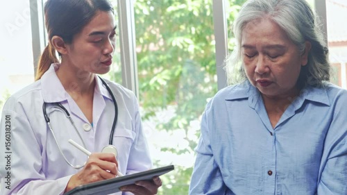 Female doctor consults an elderly female patient with physical health problems such as osteoporosis and receives some advice for caring treatment.