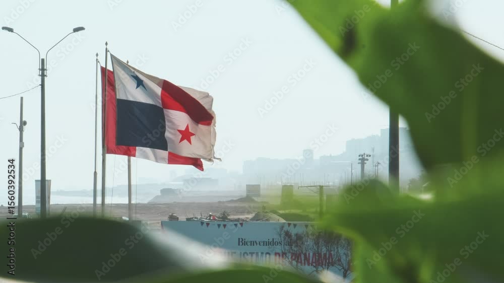 National flags of panama and peru waving in the wind on flagpoles on a sunny day