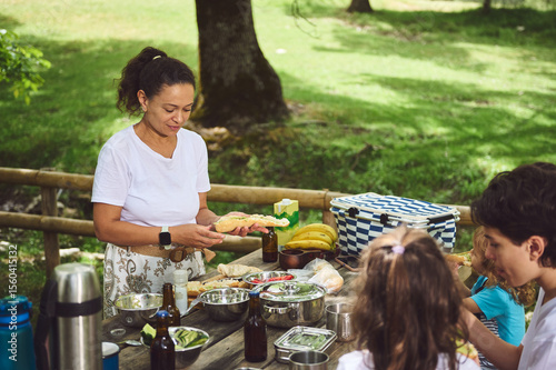 Family Enjoying a Relaxing Outdoor Picnic in a Lush Park