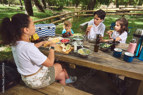Family Enjoying Outdoor Picnic Together in a Scenic Forest Setting