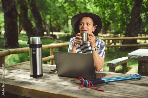 Woman Enjoying a Relaxing Outdoor Workspace in a Scenic Environment