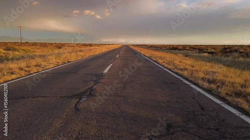 Wallpaper Mural Asphalt road across the desert at sunrise. Drone view moving forward and climbing. Torontodigital.ca