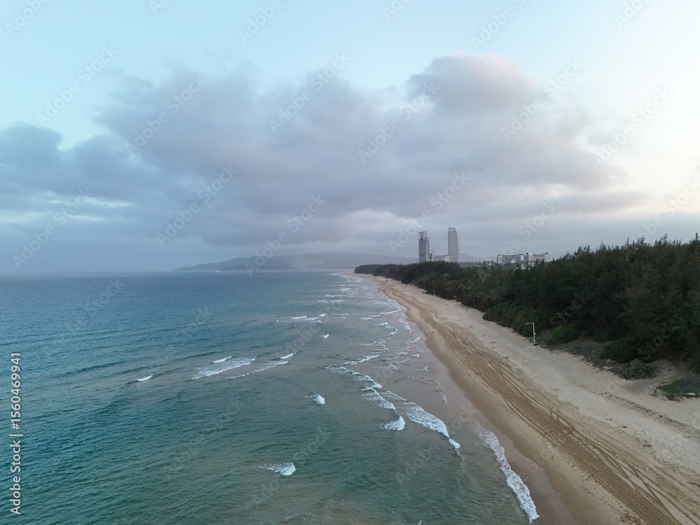 Fototapeta premium aerial view Sanya beach coastline and sea landscape at dusk. At Sanya, Haitang Bay, Hainan, China