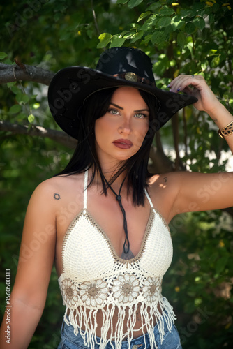 Young woman with cowboy hat portrait in nature