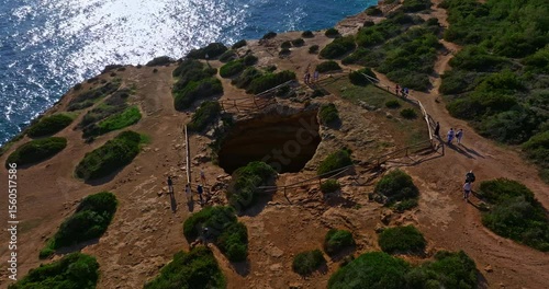 Aerial view of Benagil Cave, viewed through the circular cliff-top hole Algarve, Portugal