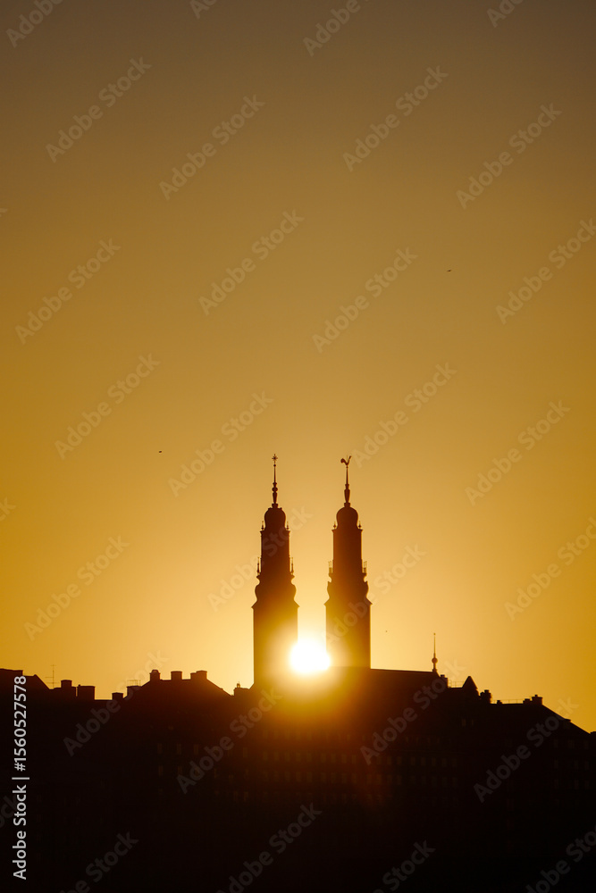 Fototapeta premium Low angle view of towers against sky during sunset