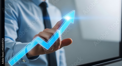 Strategic Growth Visualization A businessman interacts with a vibrant blue upward trending arrow, symbolizing progress and success in business and finance.