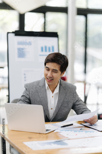 Business analytics at the office: a focused professional analyzes financial reports, embodying strategic thinking in a modern office environment. 