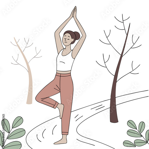 Woman in tree pose yoga position with hands raised in nature setting with trees and foliage outdoors