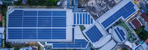 Solar roof, Solar on the roof, top view worker installing a solar cell on the factory roof, panels on tin roof seen from aerial view, panesl power.	