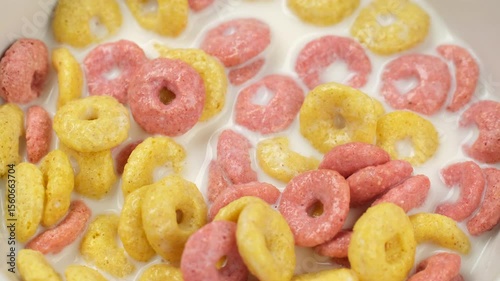 Scoop dry Breakfast cereal rings with a spoon, close up. Traditional health breakfast for family