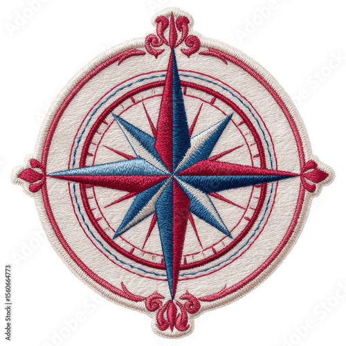 Compass rose embroidery patch with red and blue thread on white fabric showing detailed needlework and classic navigation symbol