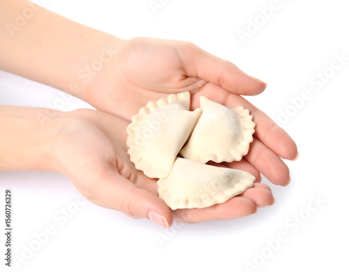 Hands holding pierogi dough on a clean background, showcasing an artisanal culinary technique