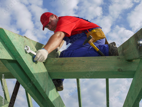 Construction Worker Installing Wooden Roof Frame on a Residential Building