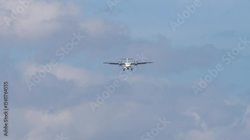 Front view of a commercial turboprop plane with unidentified livery approaching landing. Airplane in the sky. Travel concept