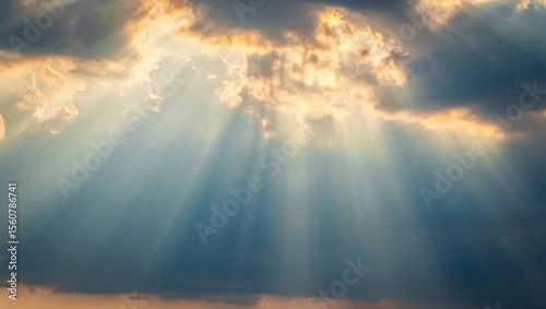 Dramatic sunbeams pierce through stormy clouds creating a breathtaking celestial light show in the sky