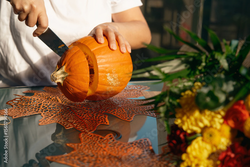 DIY project with young woman carving pumpkin