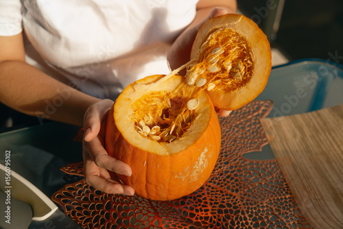 Woman making Halloween pumpkin flower centerpiece