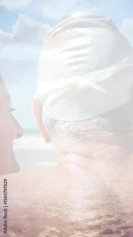 Animation of glowing light over happy senior couple in swimming hats by seaside Animation of glowing light over happy senior couple in swimming hats by seaside