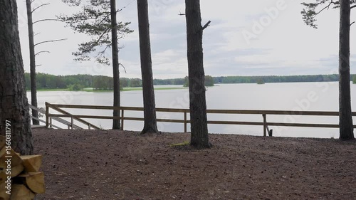 Experience the tranquility of spring in Porvoo, Finland, as gentle waves caress the seaside. Enjoy the peaceful atmosphere surrounded by nature and tall trees by the water.	