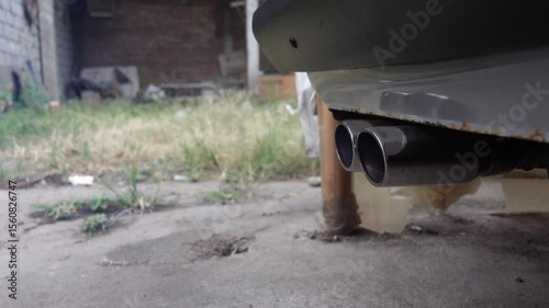 Close-up of a car’s exhaust pipe releasing smoke, symbolizing air pollution and vehicle emissions.