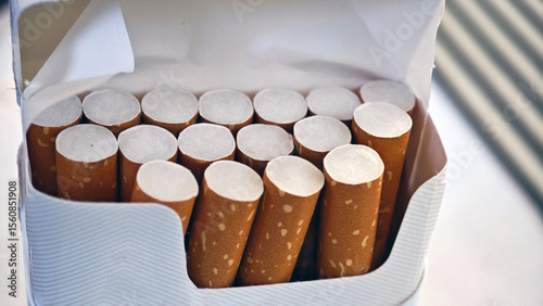 Pack of cigarettes arranged neatly in a carton ready for sale at a convenience store photo