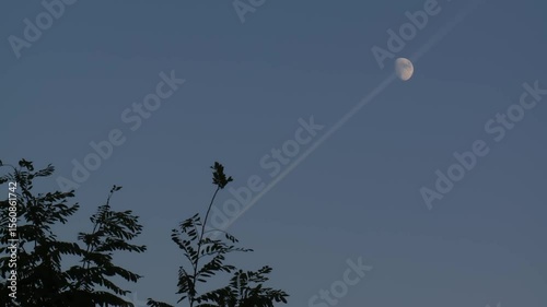 Plane Trail Across the Moon – A Moment in the Sky