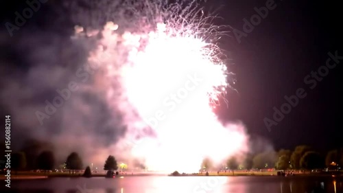 Vibrant Fireworks Reflect on Calm Lake