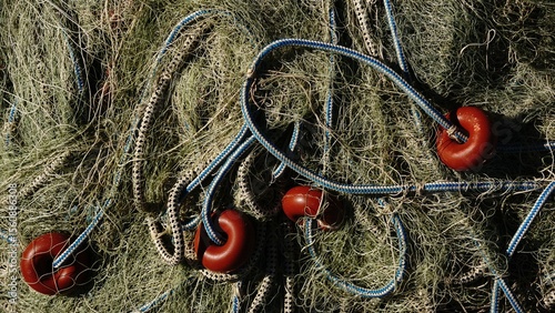 still life of fishing net threads, rope and buoy