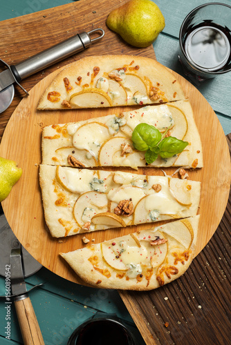 Pizza with a pear on a round board