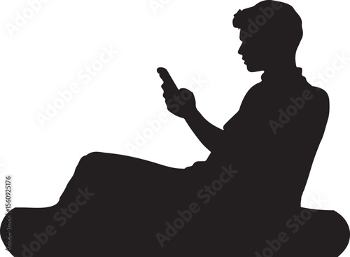 Silhouette of a Young Man Relaxing and Using a Smartphone