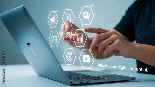 Person interacting with digital icons on a laptop screen for synapse solutions company