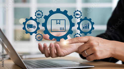 Person using laptop with digital logistics icons floating above hand in blurred setting