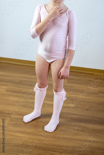 Little ballerina in light pink leotard, Small child feet in white knee high socks, Delicate white lace socks, toddler dance class, early childhood milestone, childhood development