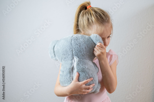 preschool sweet girl finds comfort in toy, emphasizing importance emotional support in early years, emotional attachment, childhood psychology