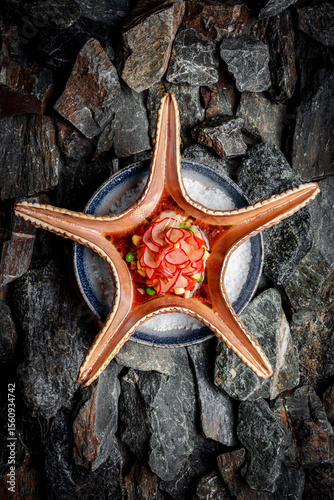 Scallop Tartare with Banana and Pickled Radish on stones