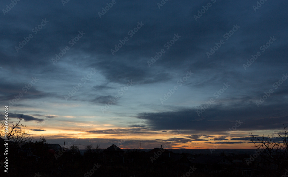 Fototapeta premium Landscape at sunset. Tragic gloomy sky. Panorama. Crimson twilight.