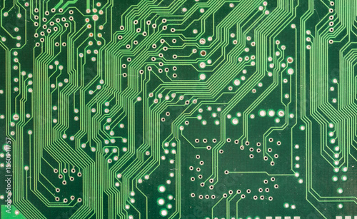 Green printed circuit board closeup with lots of electronic pathways, abstract tech simple background texture, computing, electronics PCB design hardware electronic engineering backdrop concept, front
