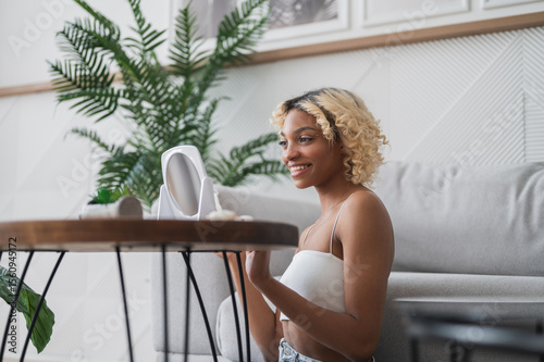 Side view on attractive woman doing face massage with gua sha scraper at home.Beauty and skin care concept