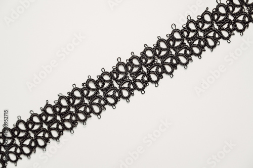 Handmade jewelry.Closeup texture of Necklace or bracelet made with Tatting or frivolite concept.Copy space banner 