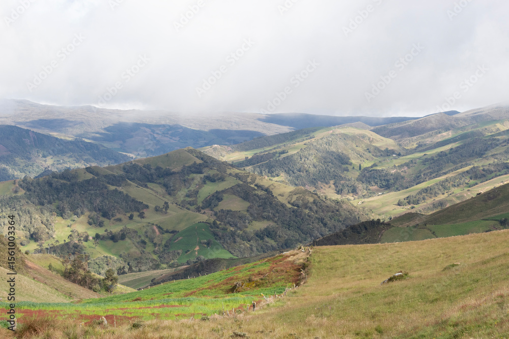 Obraz premium Beautiful sunset landscape of colombian andean mountain range with grey cloudy sky