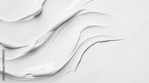 White cosmetic product texture in flowing strokes.